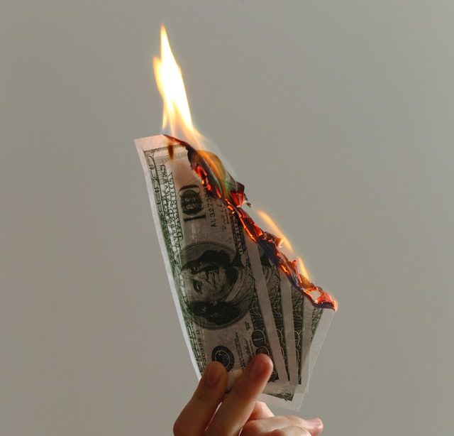 One hundred dollar bills burning